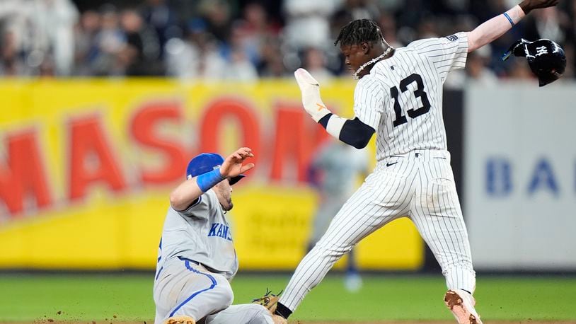 New York Yankees' Jazz Chisholm Jr. (13) slides safely into second base ahead of the tag from Kansas City Royals second baseman Michael Massey during the seventh inning of Game 1 of the American League baseball division series, Saturday, Oct. 5, 2024, in New York. (AP Photo/Frank Franklin II)