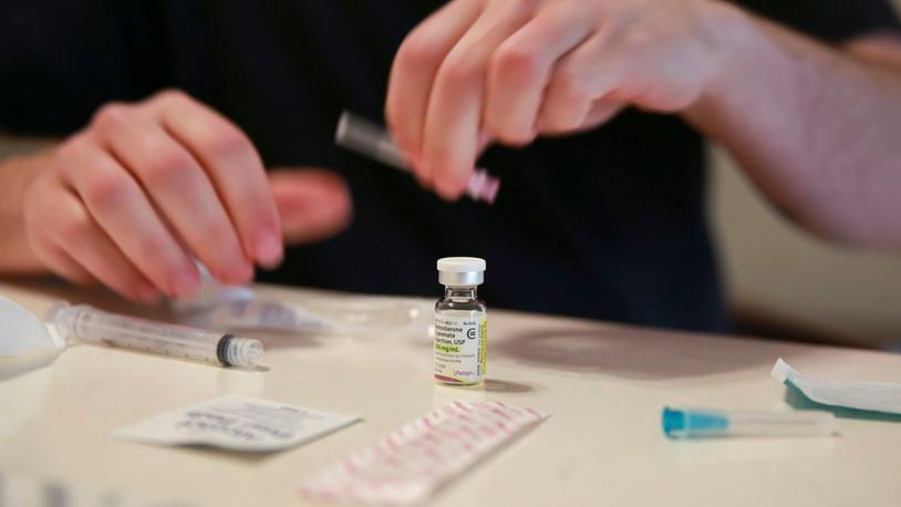 FILE - Lucas prepares his weekly testosterone shot at his home in Casselberry, Fla., May 29, 2023. The Associated Press is not using Lucas' last names because he fears reprisal. (AP Photo/Laura Bargfeld, File)