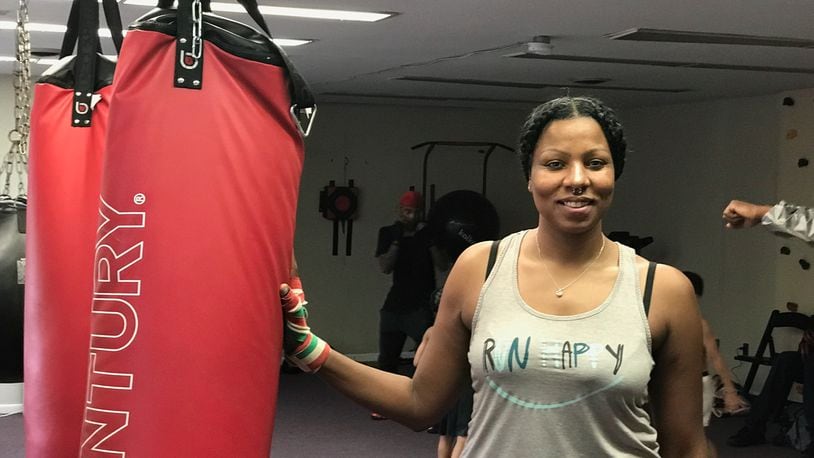 Chia Fei before she starts working on the heavy bag a few evenings ago at the King of Kingz gym in Cincinnati. The 42-year-old mother of three – a product of Belmont High and Sinclair Community College who now lives in Kettering – has had three pro bouts, all on the road, Her hometown debut is scheduled for October 19 at a gala show at the Flyght Academy in Trotwood. Tom Archdeacon/CONTRIBUTED