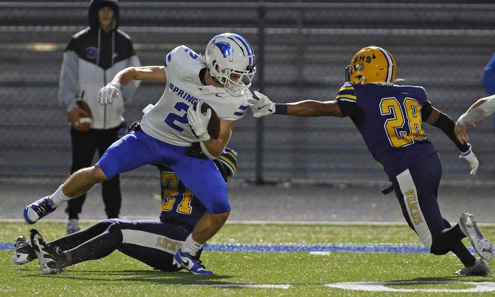 Springboro's Drew Balogh is tackled by Springfield's Rashad Walker Cherry and Ty'Juan Wright. BILL LACKEY/STAFF