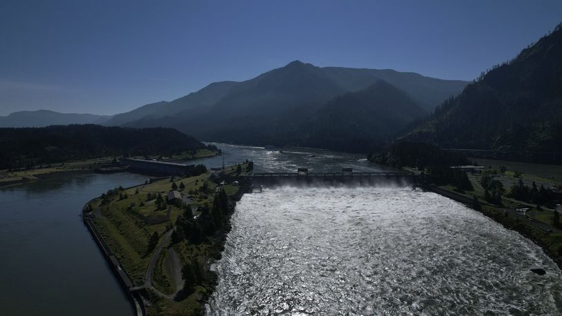 FILE - Water spills over the Bonneville Dam on the Columbia River, which runs along the Washington and Oregon state line, on Tuesday, June 21, 2022. The U.S. government on Tuesday, June 18, 2024, acknowledged for the first time the harms that the construction and operation of dams on the Columbia and Snake rivers in the Pacific Northwest have caused Native American tribes, issuing a report that details how the unprecedented structures devastated salmon runs, inundated villages and burial grounds, and continue to severely curtail the tribes' ability to exercise their treaty fishing rights. (AP Photo/Jessie Wardarski, File)