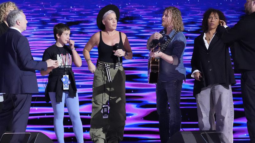 Pink, center, stands on stage during a sound check before the start of night four of the Democratic National Convention Thursday, Aug. 22, 2024, in Chicago. (AP Photo/J. Scott Applewhite)