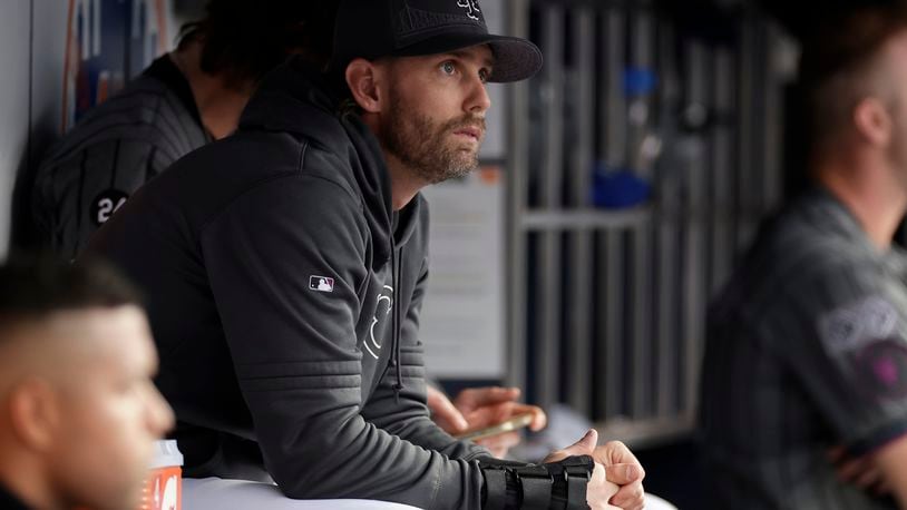 New York Mets second baseman Jeff McNeil, with a splint on his wrist, looks on from the dugout during the third inning of a baseball game against the Cincinnati Reds, Saturday, Sept. 7, 2024, in New York. (AP Photo/Adam Hunger)