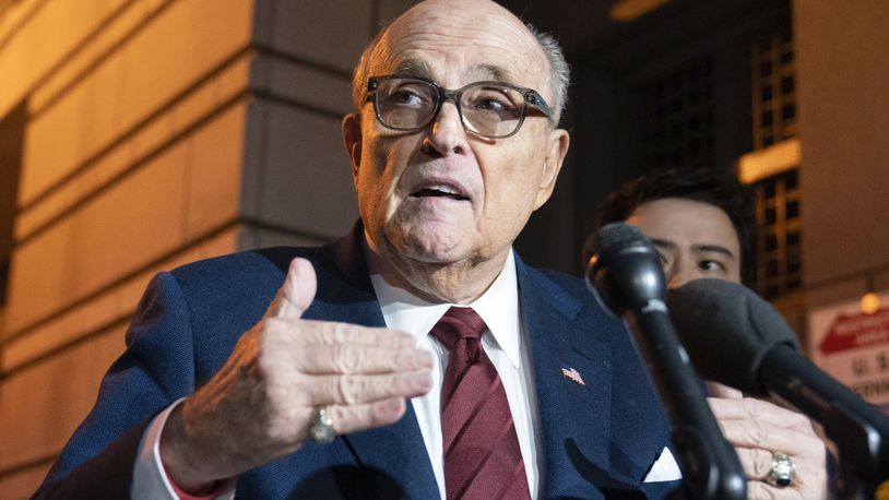 FILE - Former New York Mayor Rudy Giuliani talks to reporters as he leaves the federal courthouse in Washington, Dec. 11, 2023. A judge said Wednesday, July 10, 2024, he was leaning toward throwing out Giuliani's bankruptcy case after lawyers and his biggest creditors agreed this was the best way forward. (AP Photo/Jose Luis Magana, File)
