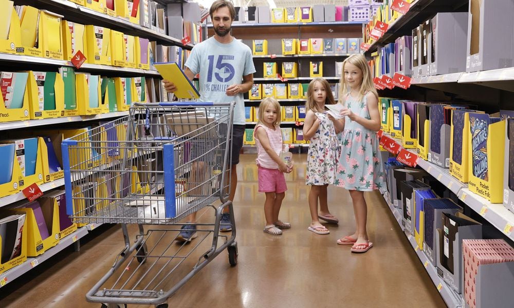 Zack Hinger shops for school supplies with daughters Lily, 8, Theresa, 6, and Cece, 4, at Walmart Tuesday, July 23, 2024 in West Chester Township. Ohio's sales tax holiday is July 30 to Aug. 8 running 10 days instead of 3 days from last year and includes more than just school supplies and clothing. NICK GRAHAM/STAFF