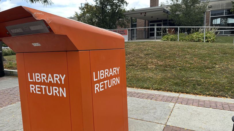 The return box sits outside of the closed library, Monday, Sept. 23, 2024, in Royal, Oak, Michigan, after someone returned a DVD with bugs inside the case. (AP Photo/Mike Householder)