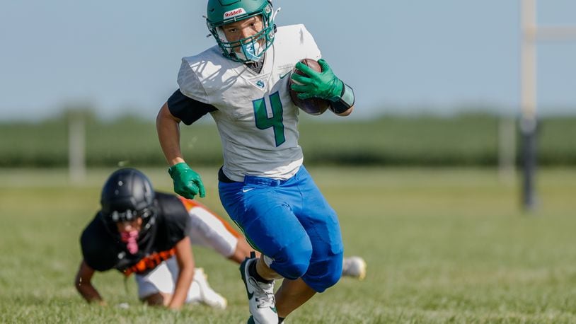 Chaminade-Julienne's Malachi Maddox-Ringer runs the ball during a scrimmage vs. Minster earlier this month. Michael Cooper/CONTRIBUTED