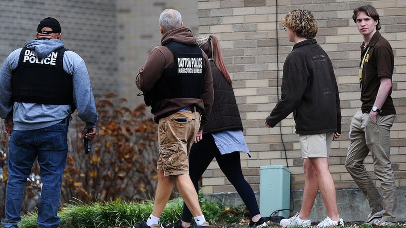 Members of the Kettering and Dayton Police Departments escort Archbishop Alter High School students to the gym Wednesday, Nov. 8, 2023 after a report of shots fired at the school. MARSHALL GORBY\STAFF