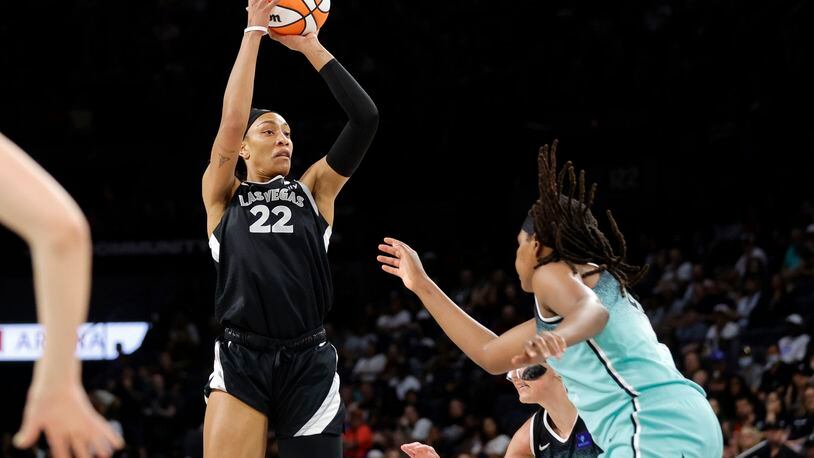 Las Vegas Aces center A'ja Wilson (22) shoots over New York Liberty forward Jonquel Jones, right, during the first half of a WNBA basketball game Saturday, Aug. 17, 2024, in Las Vegas. (Steve Marcus/Las Vegas Sun via AP)