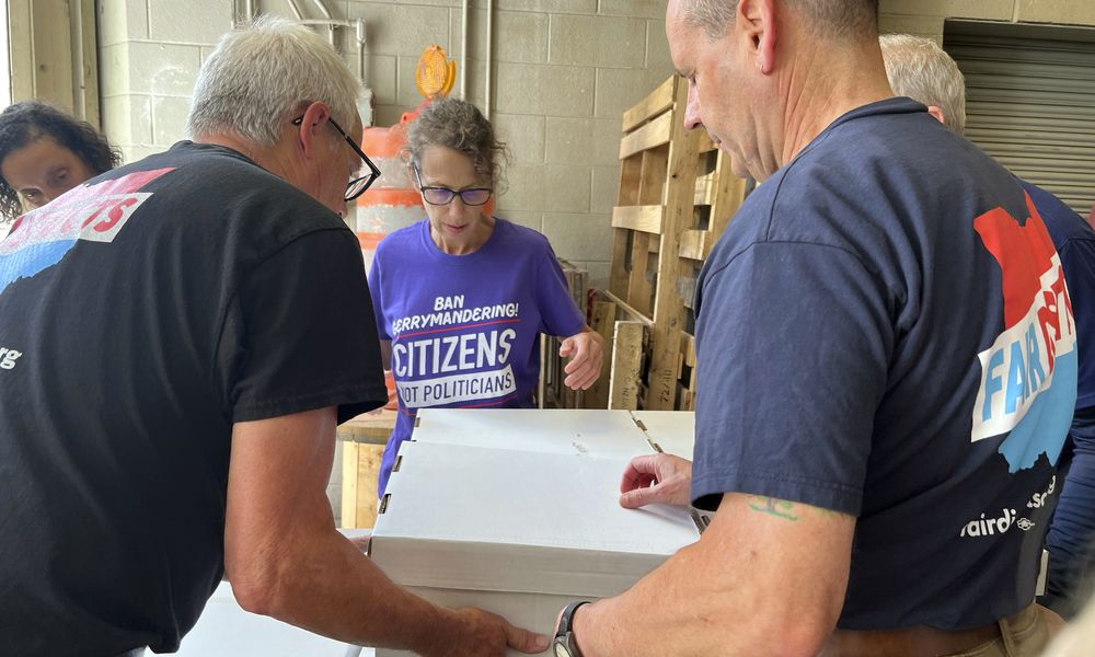 Volunteers with Citizens Not Politicians load boxes of signed petitions to Secretary of State Frank LaRose's office on Monday, July 1, 2024, in Columbus, Ohio. Backers of a proposal to change Ohio's troubled political mapmaking system delivered hundreds of thousands of signatures on Monday as they work to qualify for the statewide ballot this fall. (AP Photo/Patrick Orsagos)