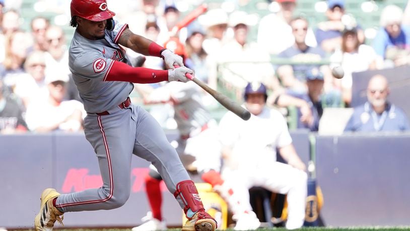 Cincinnati Reds' Santiago Espinal hits a two-run single during the fourth inning of a baseball game against the Milwaukee Brewers, Sunday, Aug. 11, 2024, in Milwaukee. (AP Photo/Aaron Gash)