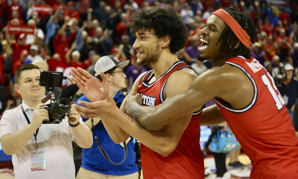 Dayton's Nate Santos and DaRon Holmes II celebrate a victory against LSU in the first round of the Charleston Classic on Thursday, Nov. 16, 2023, at TD Arena in Charleston, S.C. David Jablonski/Staff