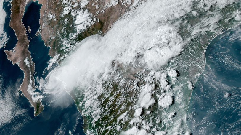 This satellite image provided by the U.S. National Oceanic and Atmospheric Administration shows Tropical Storm Ileana, left, near the coastal Mexican city of Topolobampo on the eastern side of the Gulf of California, on Saturday, Sept. 14, 2024, at 6:10 p.m. EDT. (NOAA via AP)