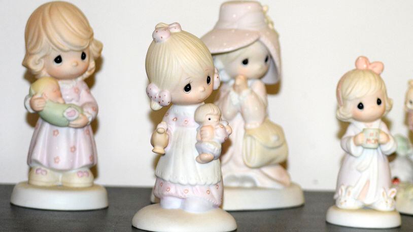 A selection of Precious Moments figurines sit on a shelf, Thursday, May 23, 2024, in Blaine, Minn. Sam Butcher, the artist who created the Precious Moments figurines depicting angelic teardrop-eyed children, died early Monday, May 20, 2024, surrounded by family. He was 85. (Lissa Forliti-Aska via AP)