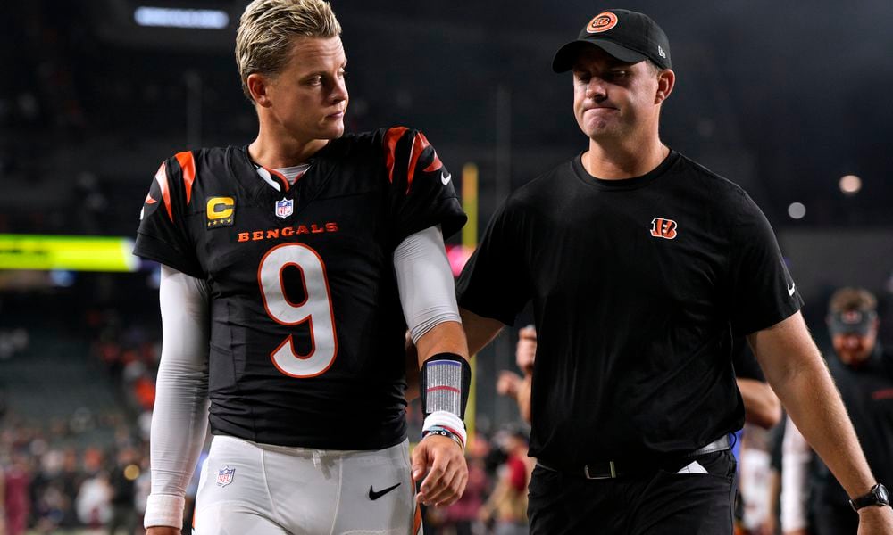 Cincinnati Bengals quarterback Joe Burrow (9) walks off the field with head coach Zac Taylor after an NFL football game against the Washington Commanders, Monday, Sept. 23, 2024, in Cincinnati. The Commanders won 38-33. (AP Photo/Jeff Dean)