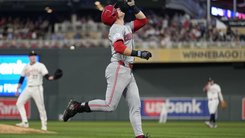 Cincinnati Reds' TJ Friedl points while running the bases after hitting a 2-run home run during the fourth inning of a baseball game against the Minnesota Twins, Saturday, Sept. 14, 2024, in Minneapolis. (AP Photo/Abbie Parr)