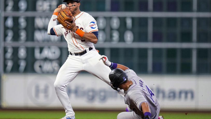 Houston Astros shortstop Jeremy Pena, left, looks to first after forcing out Colorado Rockies' Ezequiel Tovar during the fourth inning of a baseball game Tuesday, June 25, 2024, in Houston. Ryan McMahon advanced to second on the play on a throwing error by Pena. (AP Photo/Eric Christian Smith)
