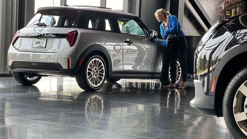 A prospective buyer examines a 2025 Cooper S hardtop on display on the showroom floor of a Mini dealership Monday, July 22, 2024, in Highlands Ranch, Colo. (AP Photo/David Zalubowski)