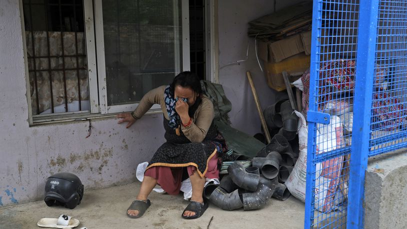 A woman cries after she lost her home due to floods caused by heavy rains in Kathmandu, Nepal, Saturday, Sept. 28, 2024. (AP Photo/Gopen Rai)