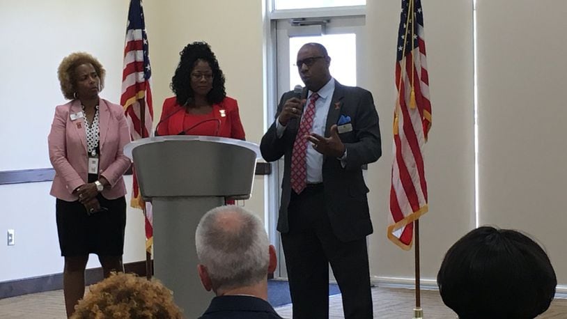 Trotwood-Madison schools interim superintendent Tyrone Olverson explains recent changes in the district as treasurer Janice Allen (left) and school board president Denise Moore look on Friday, Aug. 24, 2018. JOSH SWEIGART / STAFF