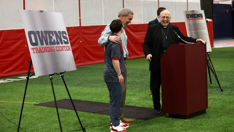 Joe Owens puts his arm around Colin Connor during a dedication of the Joe Owens Training Facility at Dayton's Cronin Center on Tuesday, April 18, 2023. David Jablonski/Staff