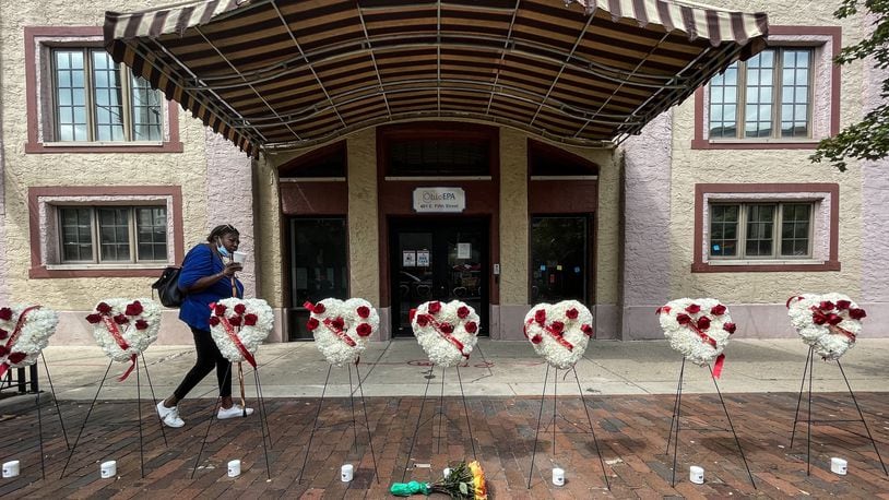 A women walks by a makeshift memorial of the nine people who where killed two years ago today in the Oregon District mass shooting in Dayton, Ohio. Jim Noelker/Staff