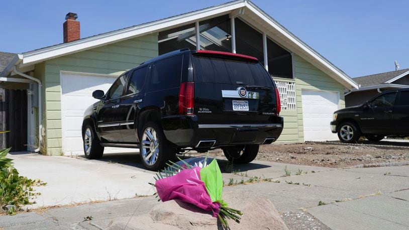 Flowers are seen in front of a home at a residence on Kitty Hawk Road in the City of Alameda, Calif. on Thursday, July 11, 2024. A California man is in custody after fatally shooting his wife, their 6-year-old son and his wife's parents, a San Francisco Bay Area police department said Thursday. (AP Photo/Terry Chea)