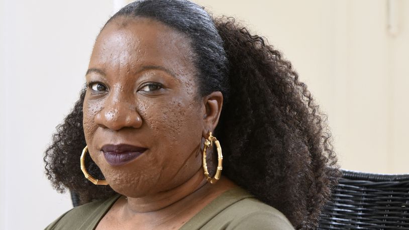 FILE - Tarana Burke, founder and leader of the #MeToo movement, sits in her home in Baltimore on Tuesday, Oct. 13, 2020. (AP Photo/Steve Ruark, File)