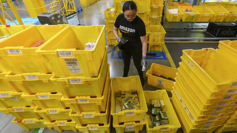 FILE - An employee scans incoming items at a receiving station at the Amazon OXR1 fulfillment center in Oxnard, Calif., on Aug. 21, 2024. (AP Photo/Damian Dovarganes, File)