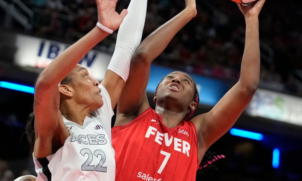 Indiana Fever's Aliyah Boston (7) shoots over Las Vegas Aces' A'ja Wilson (22) during the first half of a WNBA basketball game, Wednesday, Sept. 11, 2024, in Indianapolis. (AP Photo/Darron Cummings)