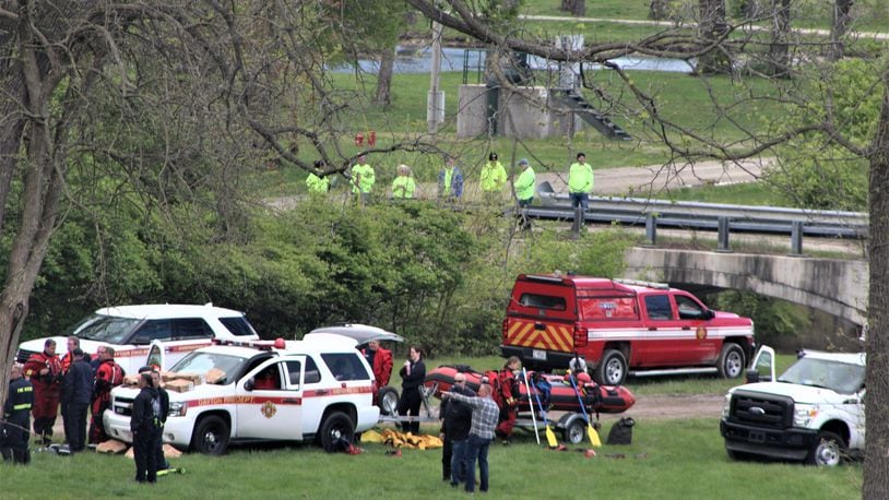 Dayton Fire Department personnel and vehicles stationed at the Mad River wellfield area near Eastwood MetroPark. Crews are searching for a 7-year-old boy who went missing Saturday evening. CORNELIUS FROLIK / STAFF