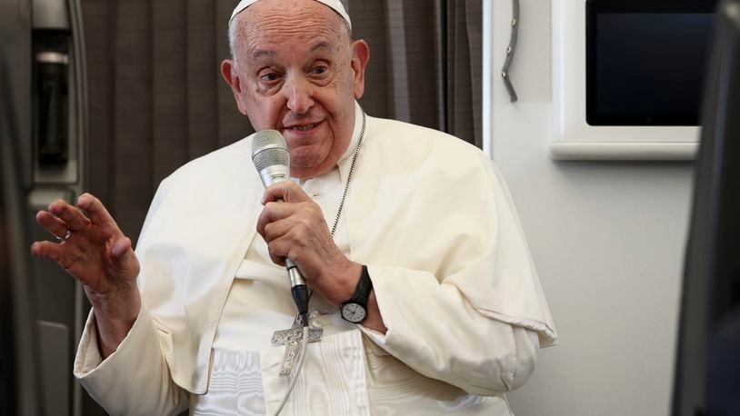 Pope Francis holds a news conference aboard the papal plane on his flight back after his 12-day journey across Southeast Asia and Oceania, Friday, Sept. 13, 2024. (Guglielmo Mangiapane/Pool Photo via AP)