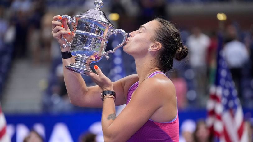 Aryna Sabalenka, of Belarus, kisses the trophy after winning the women's singles final of the U.S. Open tennis championships against Jessica Pegula, of the United States, , Saturday, Sept. 7, 2024, in New York. (AP Photo/Frank Franklin II)