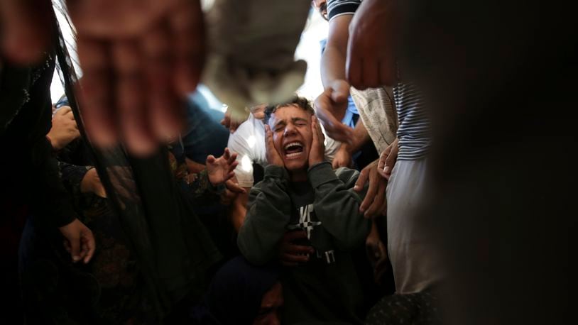 Palestinians mourn their relatives killed in the Israeli bombardment of the Gaza Strip at a hospital morgue in Khan Younis, southern Gaza Strip, Monday, June 24, 2024. (AP Photo/Jehad Alshrafi)