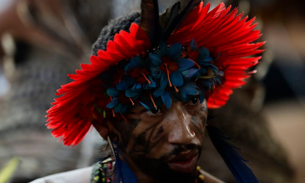 An Indigenous person attends a ceremony celebrating the return of the Tupinamba Indigenous people's sacred cloak to Brazil, in Rio de Janeiro, Thursday, Sept. 12, 2024. The garment, made from bird feathers and plant fibers, was repatriated to Brazil after having spent more than 300 years in the National Museum of Denmark. (AP Photo/Bruna Prado)