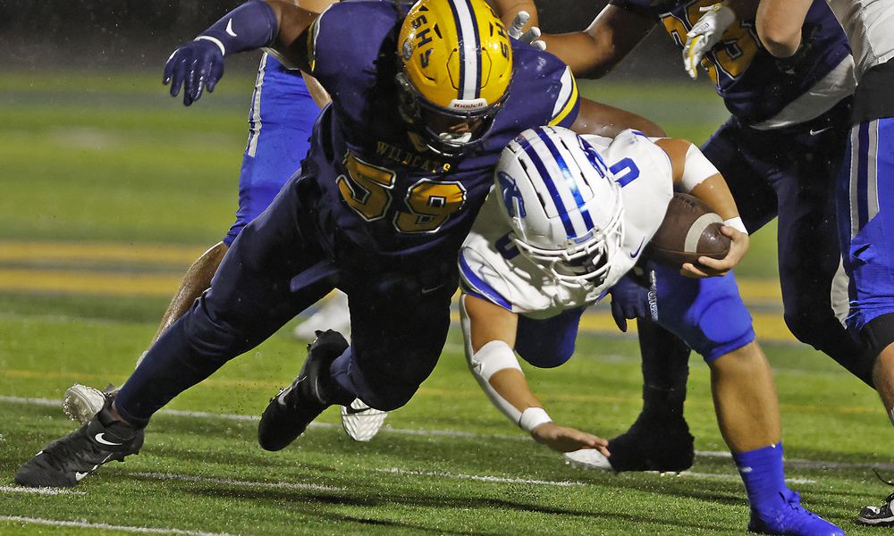 Springboro's Mattias Brunicardi is tackled by Springfield's Royce Rogers during Friday night's game in Springfield. BILL LACKEY/STAFF