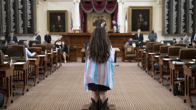 State Rep. Mary González, D - Clint, wears the colors of the transgender pride flag while speaking against House Bill 25, that limits the participation of transgender athletes in public school sports, in the House Chamber at the Capitol in Austin, Texas, on Thursday Oct. 14, 2021. (Jay Janner /Austin American-Statesman via AP)