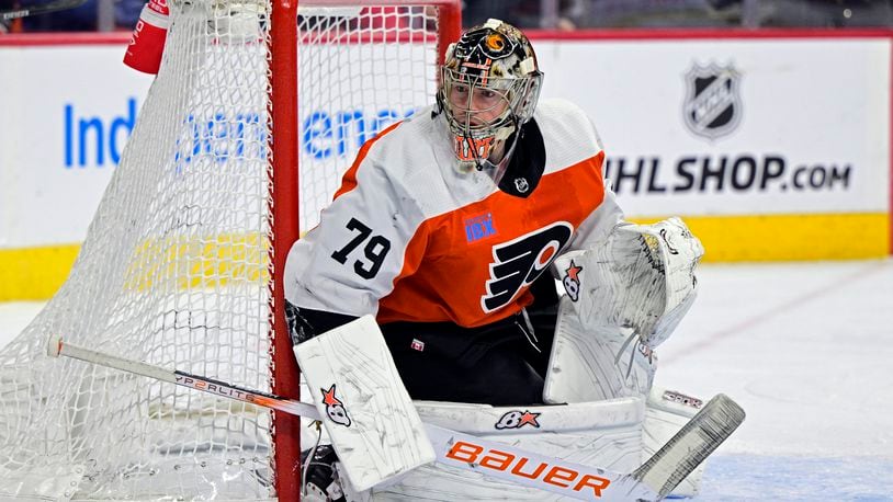 FILE - Philadelphia Flyers' goaltender Carter Hart guards the net during an NHL hockey game against the Colorado Avalanche, Jan. 20, 2024, in Philadelphia. Four current members of the National Hockey League charged with sexual assault in Canada will become free agents after not receiving qualifying offers from their respective teams. Hart was under contract with Philadelphia, Michael McLeod and Cal Foote with New Jersey and Dillon Dube with Calgary when they were charged in connection with an incident that occurred in London, Ontario, in 2018 after they were teammates on Canada's world junior team. (AP Photo/Derik Hamilton, File)