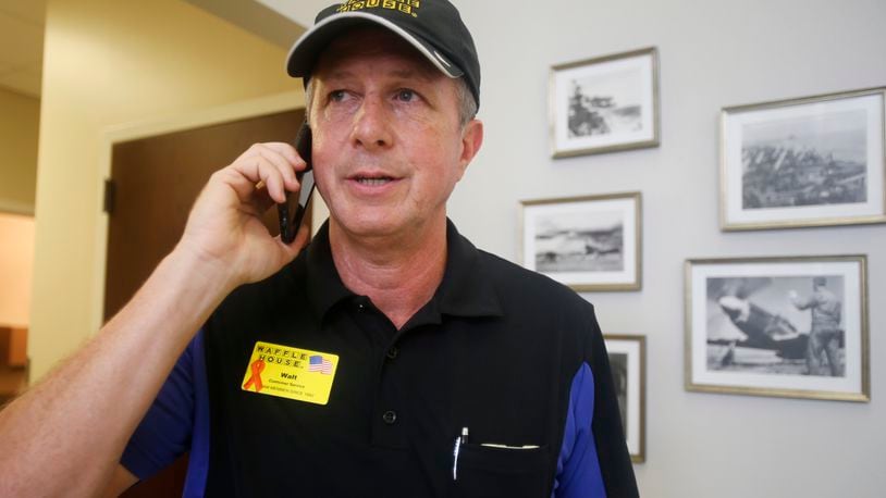 FILE - Walt Ehmer, president and CEO of Waffle House, speaks on the phone after landing at the Wilmington airport with an emergency response team in Wilmington, N.C., Sept. 17, 2018. (AP Photo/Steve Helber, File)