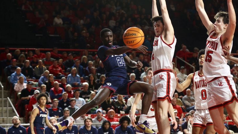 Dayton's Kobe Elvis makes a pass against Davidson on Wednesday, Jan. 3, 2024, at at Belk Arena in Davidson, N.C. David Jablonski/Staff