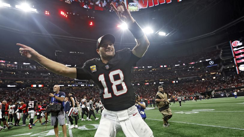 Atlanta Falcons quarterback Kirk Cousins (18) celebrates with the fans after the team defeated the Tampa Bay Buccaneers during overtime in an NFL football game Thursday, Oct. 3, 2024, in Atlanta. (AP Photo/Butch Dill)