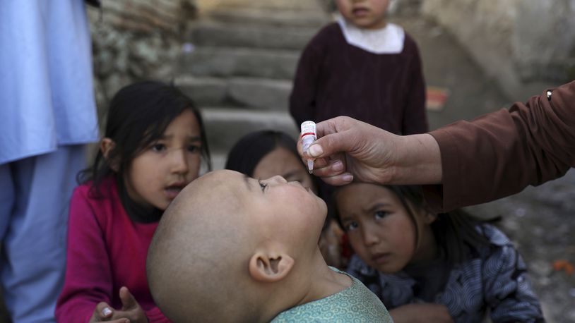 FILE - Shabana Maani, gives a polio vaccination to a child in the old part of Kabul, Afghanistan, Monday, March 29, 2021. (AP Photo/Rahmat Gul, File)