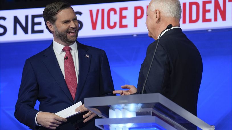 Republican vice presidential nominee Sen. JD Vance, R-Ohio, talks with Democratic vice presidential candidate Minnesota Gov. Tim Walz after the vice presidential debate hosted by CBS News Tuesday, Oct. 1, 2024, in New York. (AP Photo/Matt Rourke)