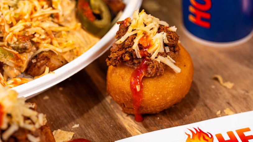 Death Grip Donuts and Hot Head Burritos are teaming up for two special pop-up events at The Mall at Fairfield Commons in Beavercreek. Pictured is The Reaper, a donut filled with chorizo and refried beans, smothered in ghost pepper sauce and topped with shredded reaper cheese (CONTRIBUTED PHOTO).