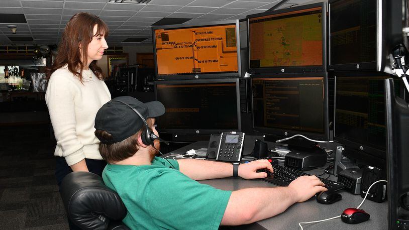 Beth Hull, left, the Miami County Communication Center’s new director, works in the communication center dispatch room in May 2024. CONTRIBUTED PHOTO