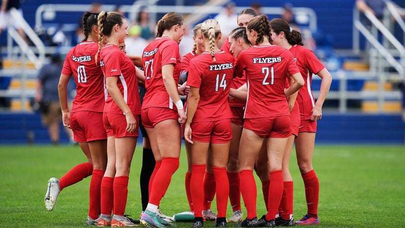 Dayton women's soccer players huddle during a scrimmage against Akron on Aug. 6 in Akron. Photo by David Cleveland