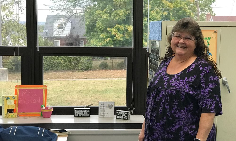 From the windows in her fifth grade classroom at Mound Elementary School, Gina Kinderdine Elson can see the house (with the white dormer) where her great grandfather, Hobby Kinderdine, a standout two-way player and kicker for the Dayton Triangles used to live. He is credited with kicking the first PAT in NFL history when he played in the leagues first ever game at Triangle Park on October 3, 1920. Tom Archdeacon/CONTRIBUTED