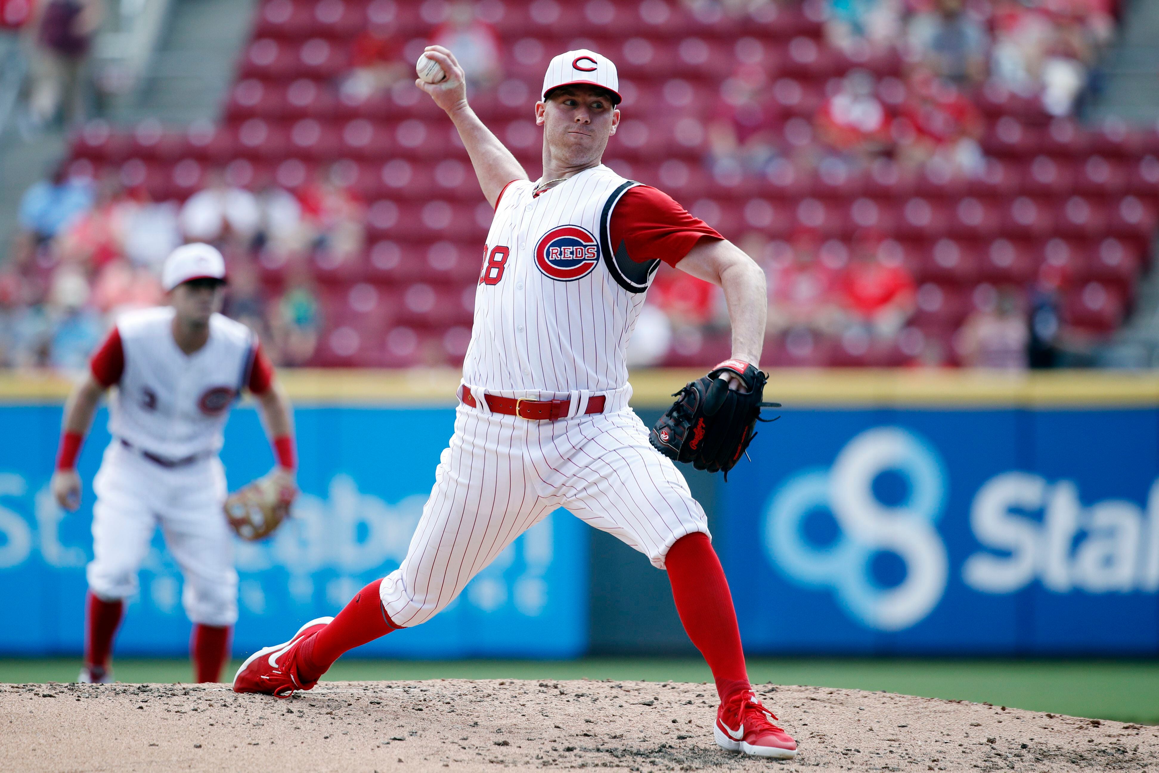 Reds play in sleeveless throwback uniforms against St. Louis Cardinals