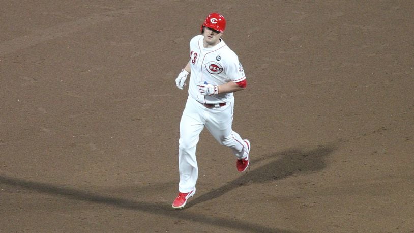 The Reds' Scott Schebler rounds the bases after a home run in the sixth inning against the Marlins on Tuesday, April 9, 2019, at Great American Ball Park.