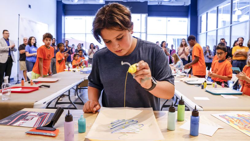 Alex Munafo, 12, works on a live art demo during the ribbon cutting for the new Fitton at the Foundry studio space at Liberty Center Tuesday, July 30, 2024. A large crowd of local elected officials, kids from Boys & Girls Club of West Chester and others filled the first ever satellite location for Fitton Center for Creative Arts. NICK GRAHAM/STAFF